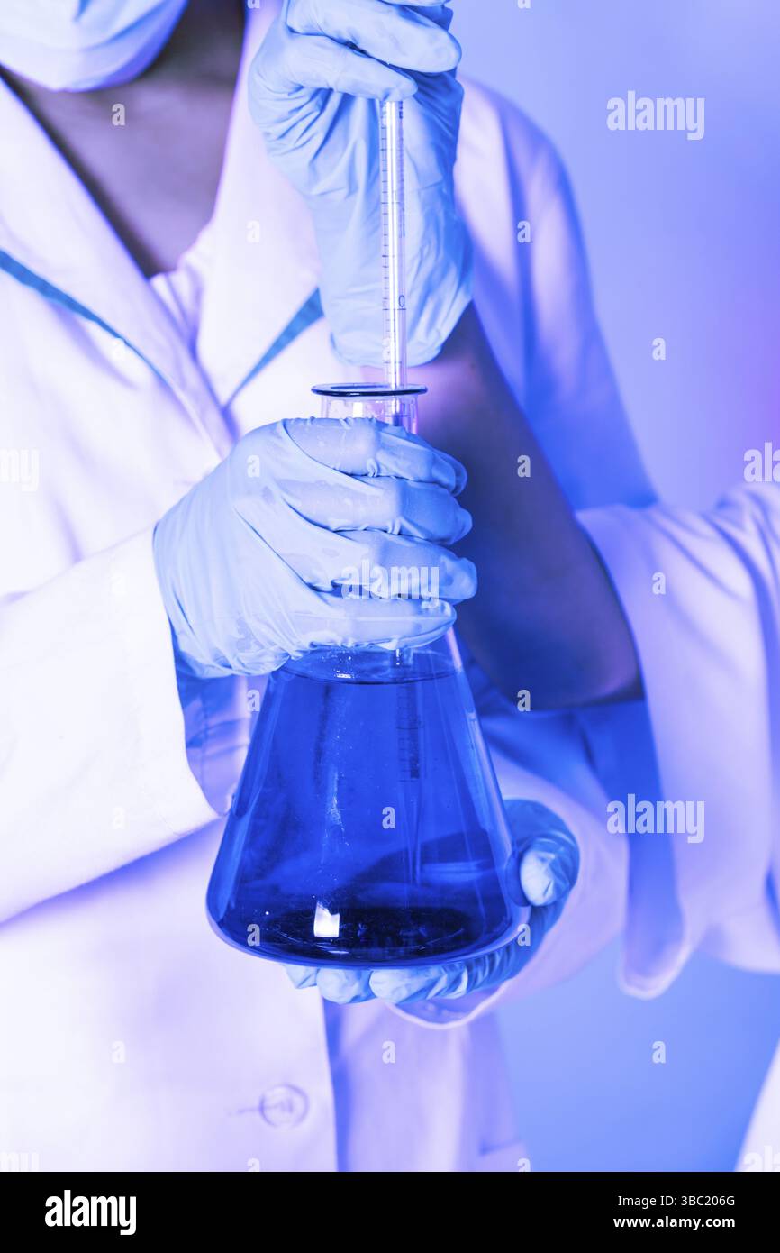 Scientist shows a diffusion in the flask Stock Photo