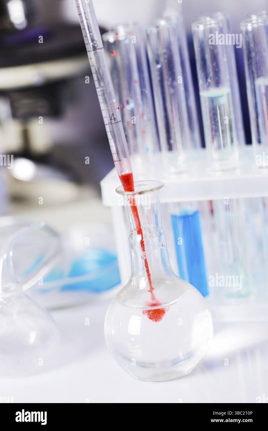 Scientist shows a diffusion in the flask Stock Photo