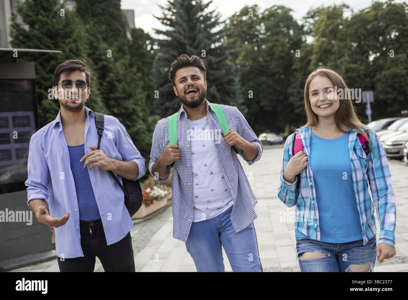 Group of high school students talking and laughing in the street Stock Photo