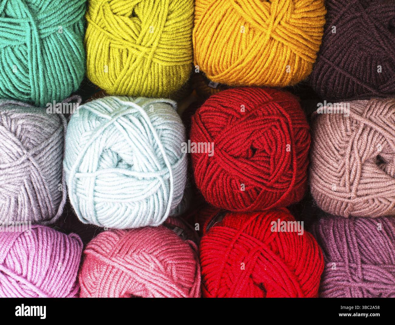 Various colors threads on rows in the store Stock Photo