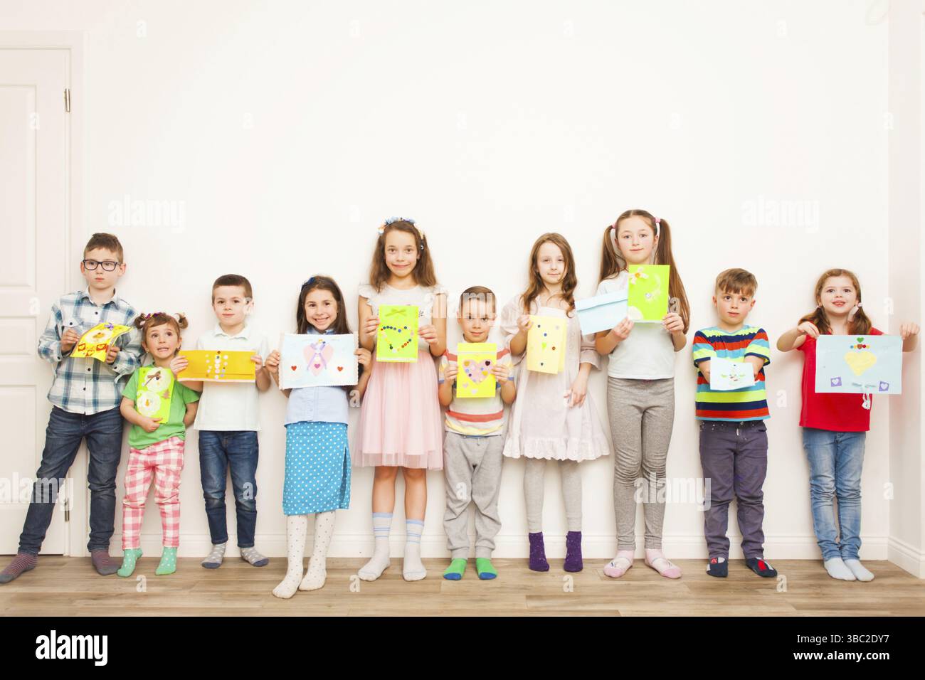 Group of children holding their handmade crafts after master class over ...