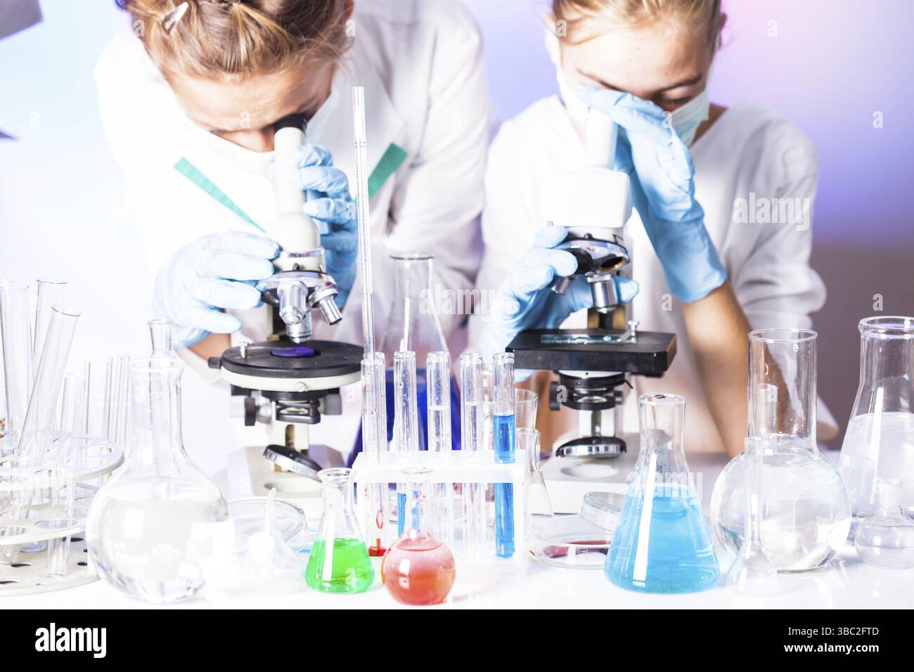Two scientists in the chemical laboratory are doing experiments Stock Photo