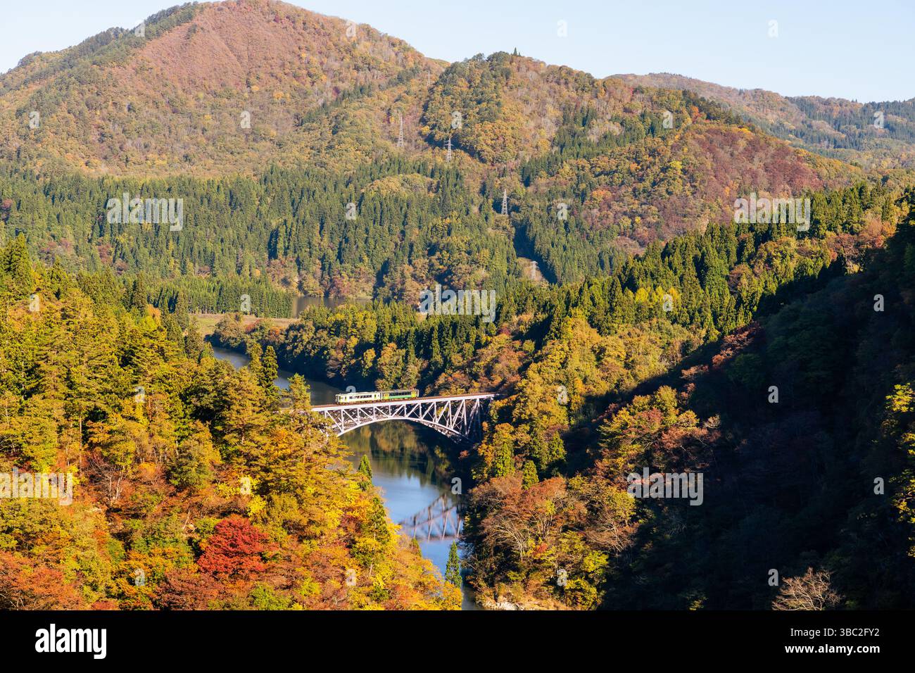 Fukushima, JAPAN - Nov 10, 2024: Train run cross Daichi Tagamigawa Bridge view from First Tadami River Bridge Stock Photo