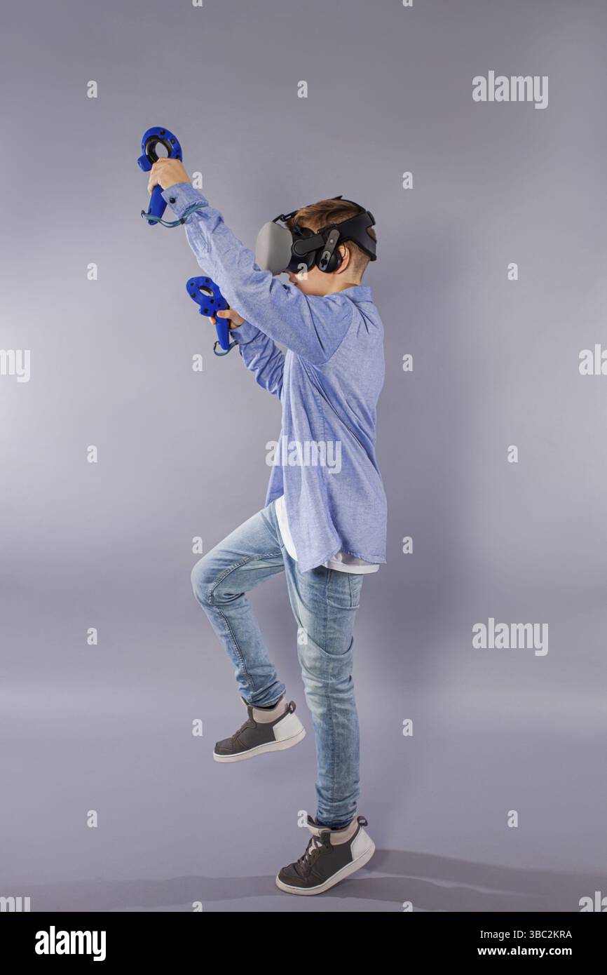 Teenager boy using the virtual reality glasses for virtual reality. Augmented reality in gaming Stock Photo