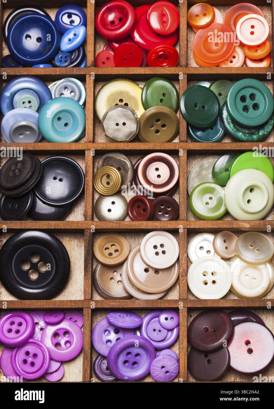 Colorful buttons in a wooden box for design Stock Photo - Alamy