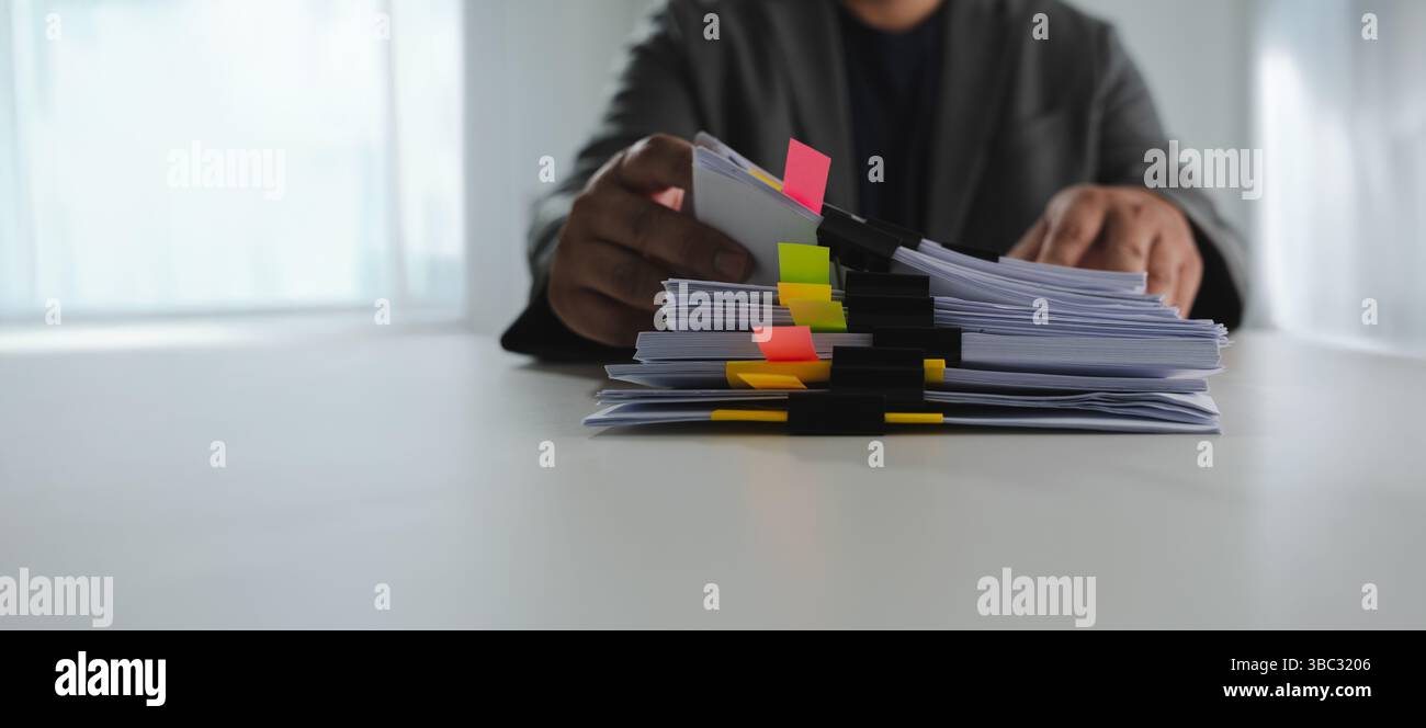 A document stacks of paper files person organizing large stack of ...