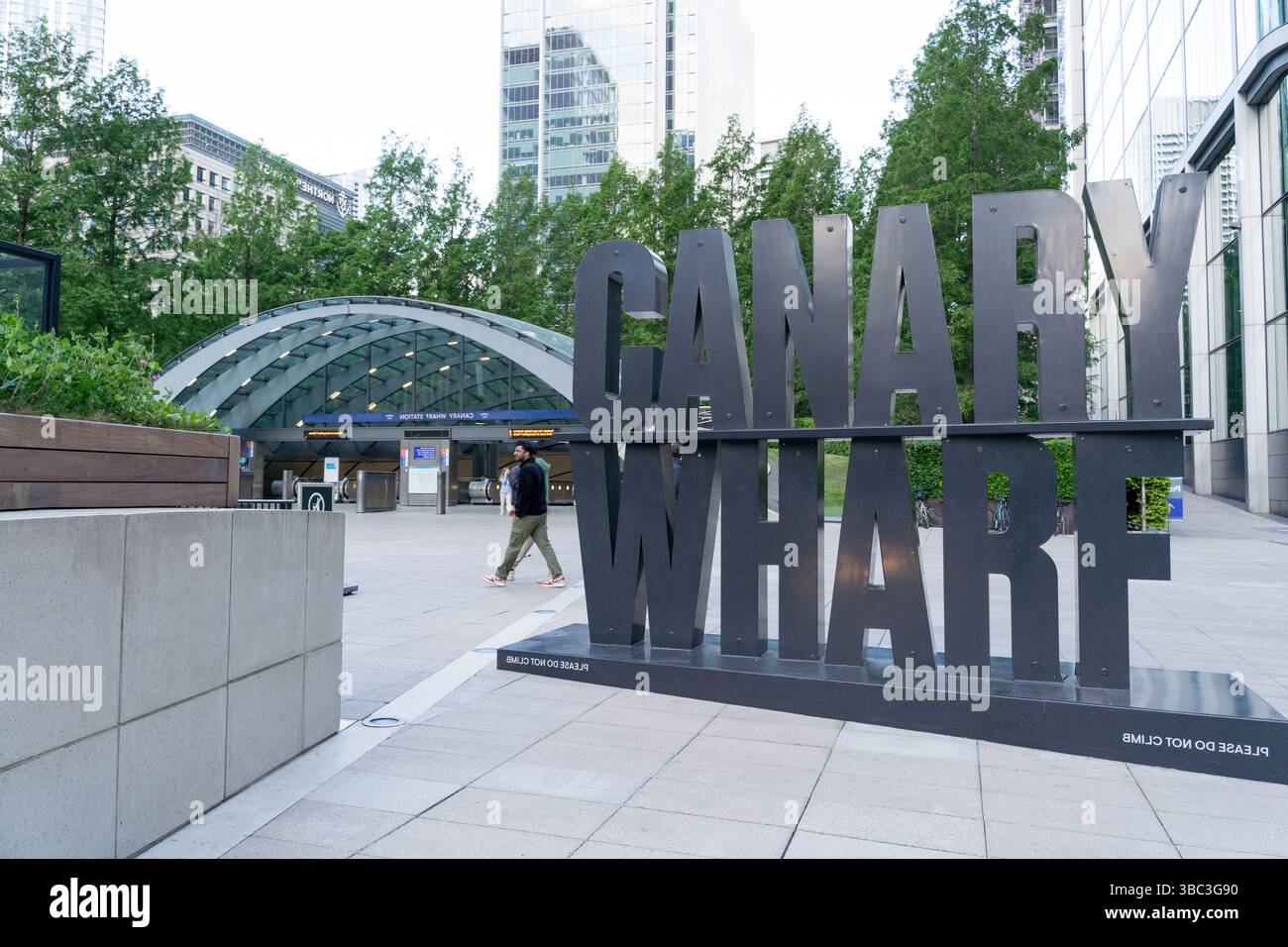 Large standalone "Canary Wharf" branding prominently displayed outside the entrance to the London Underground station, commercial hubs , UK Stock Photo