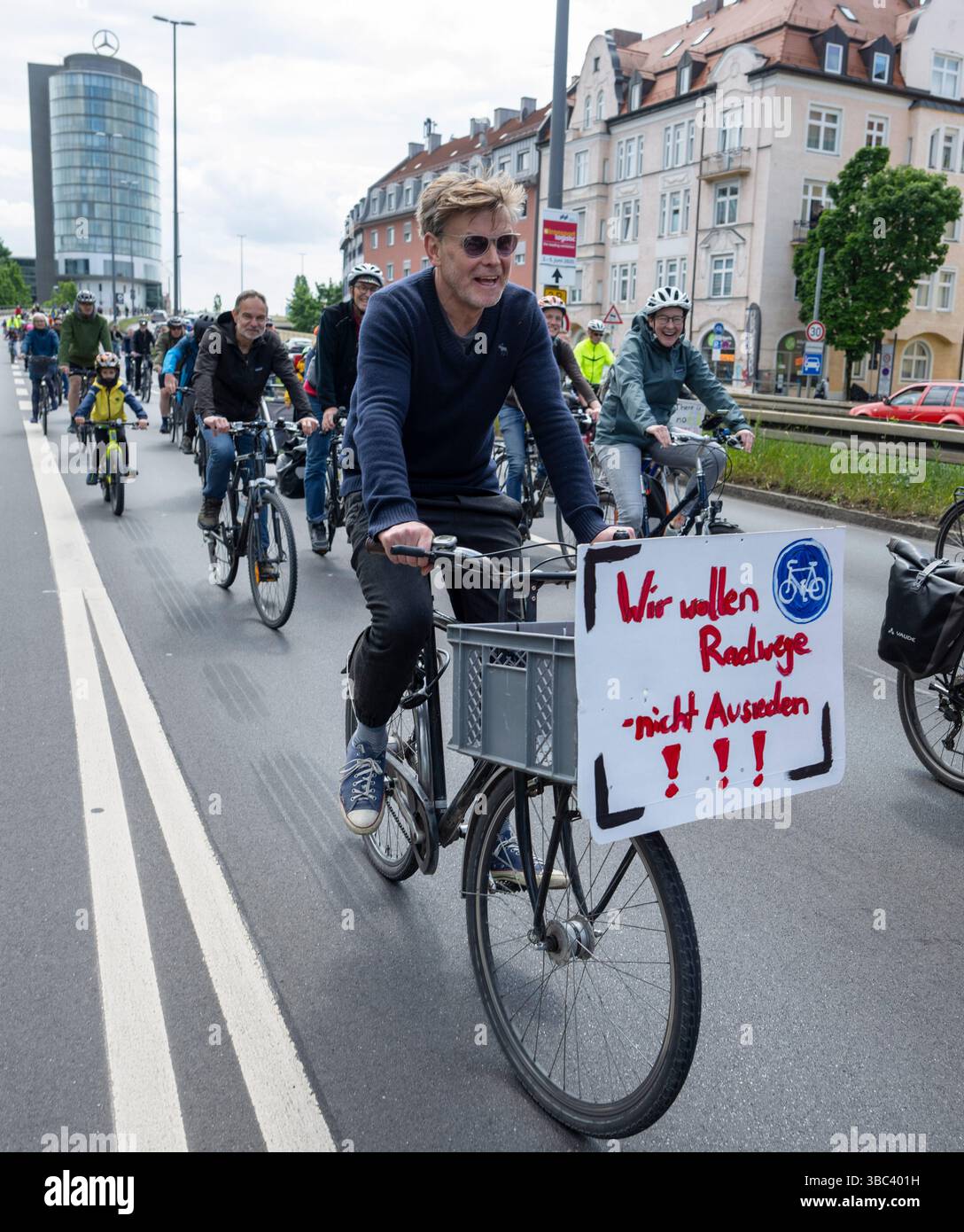 Munich, Germany. 18th May, 2025. Cyclists cross the central ring road