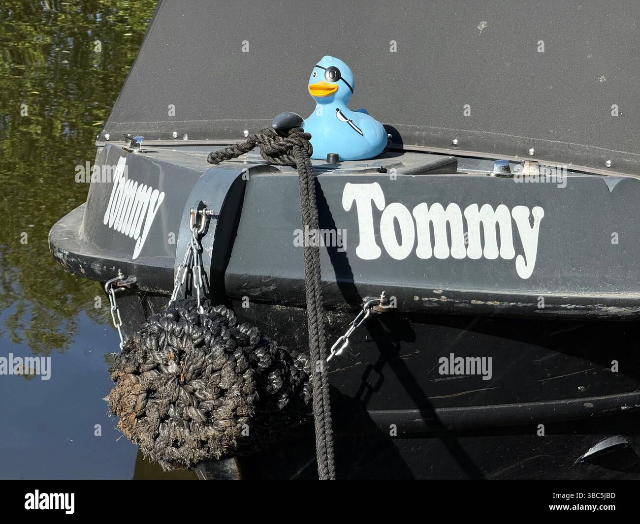Pirate plastic duck on the bow of narrow boat called Tommy on the Leeds and Liverpool canal at Wigan Pier - Smartphone Captured Stock Image