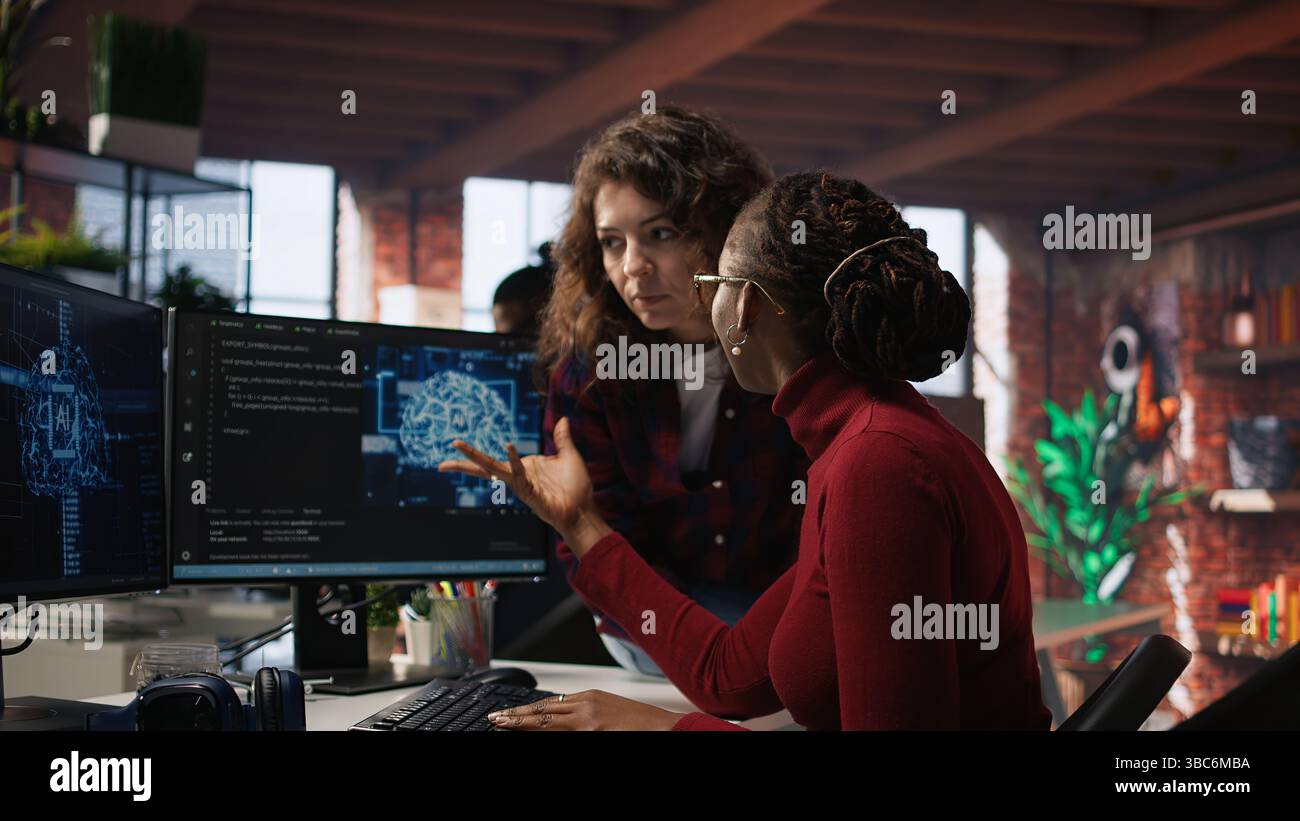 Teamworking engineers coding advanced AI algorithm and machine learning models enhancing automation. Employee talking with coworker in artificial intelligence Silicon Valley workspace, camera A Stock Photo
