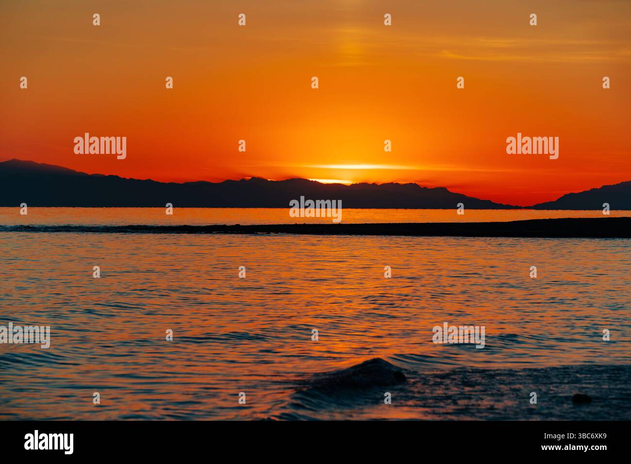 Fiery red sunset over lake Stock Photo