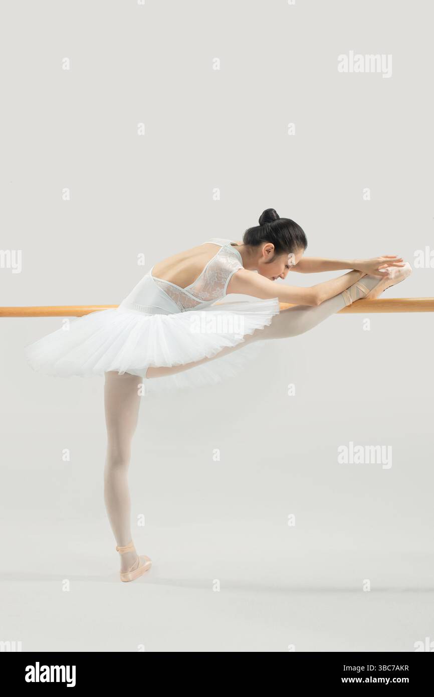 a ballet dancer practicing at the barre​ Stock Photo