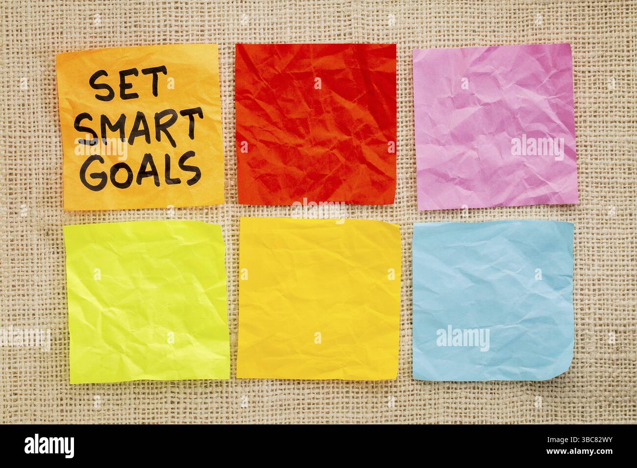 Set smart goals - handwriting on sticky notes against burlap canvas ...