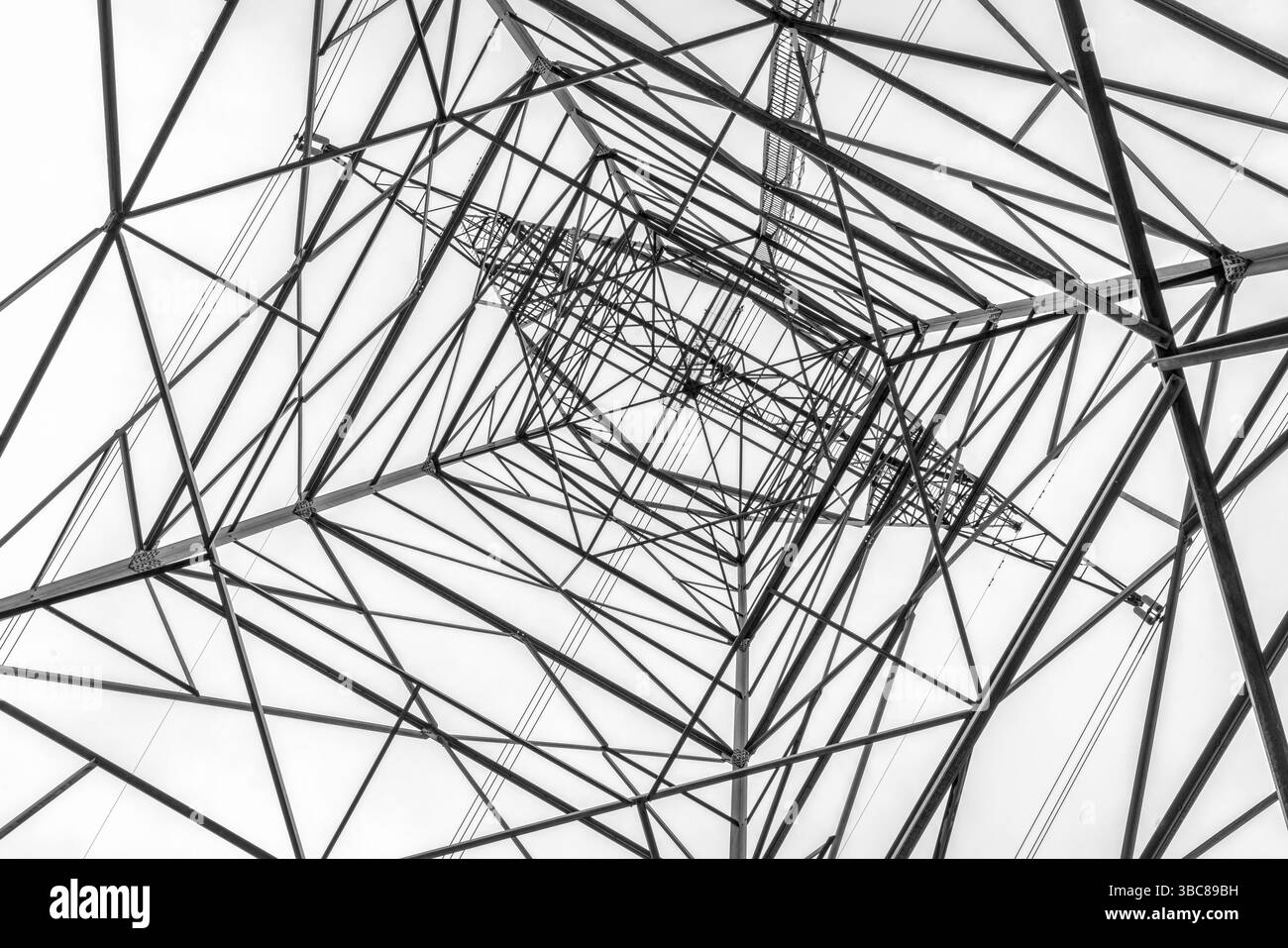Tall power line pylon silhouette against sky looking up Stock Photo - Alamy