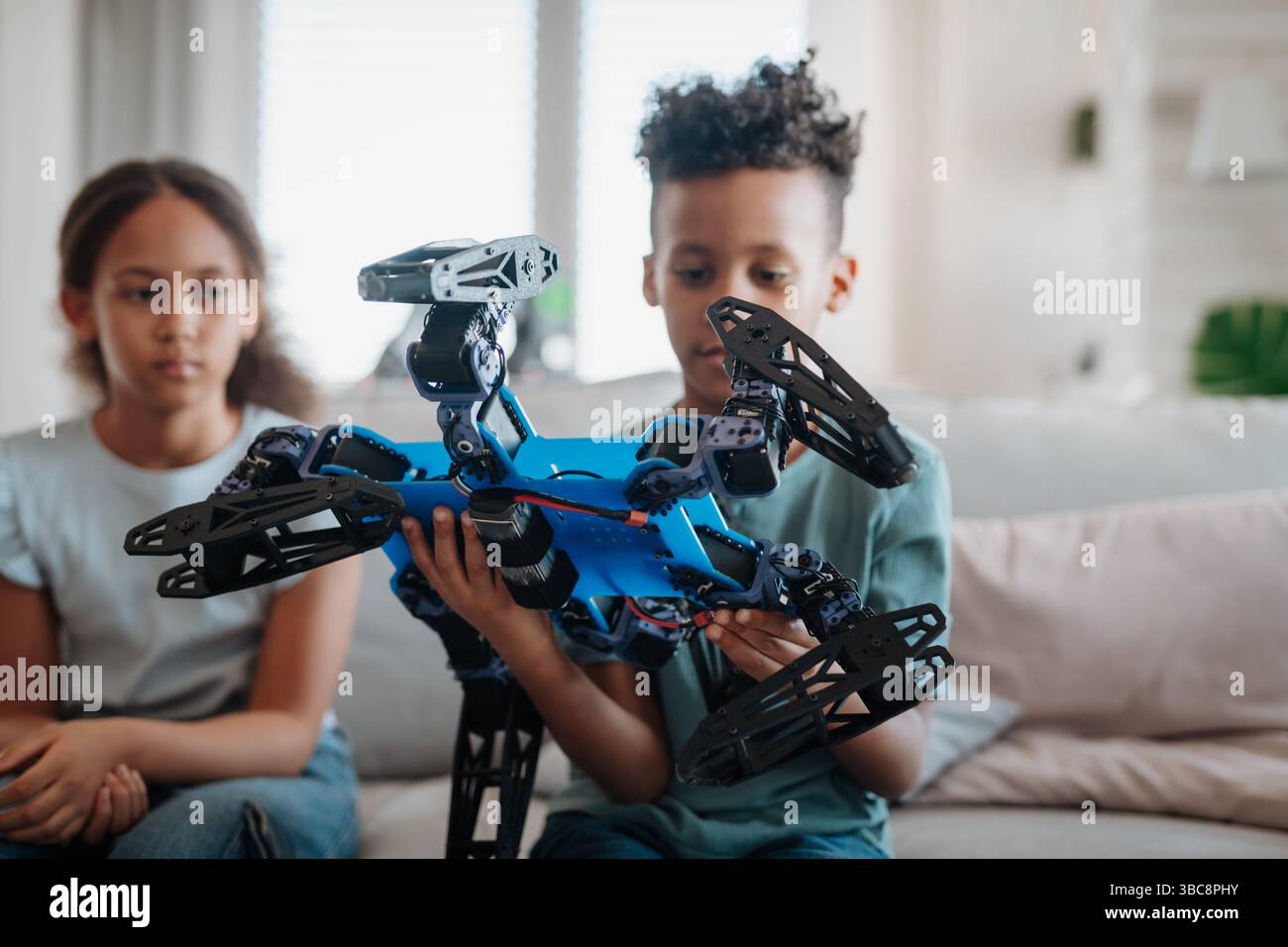 Kids playing with drone at home Stock Photo - Alamy