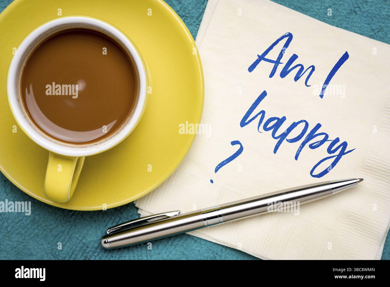 Am I happy? Handwriting on a napkin with a cup of coffee Stock Photo