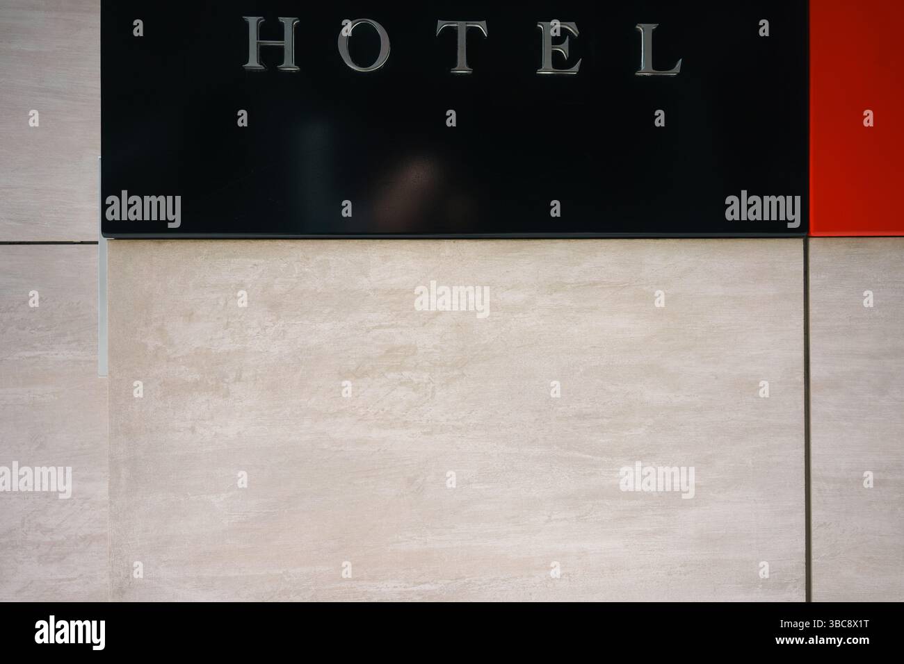 The inscription Hotel in metal letters on a marble wall. Abstract composition. Stock Photo