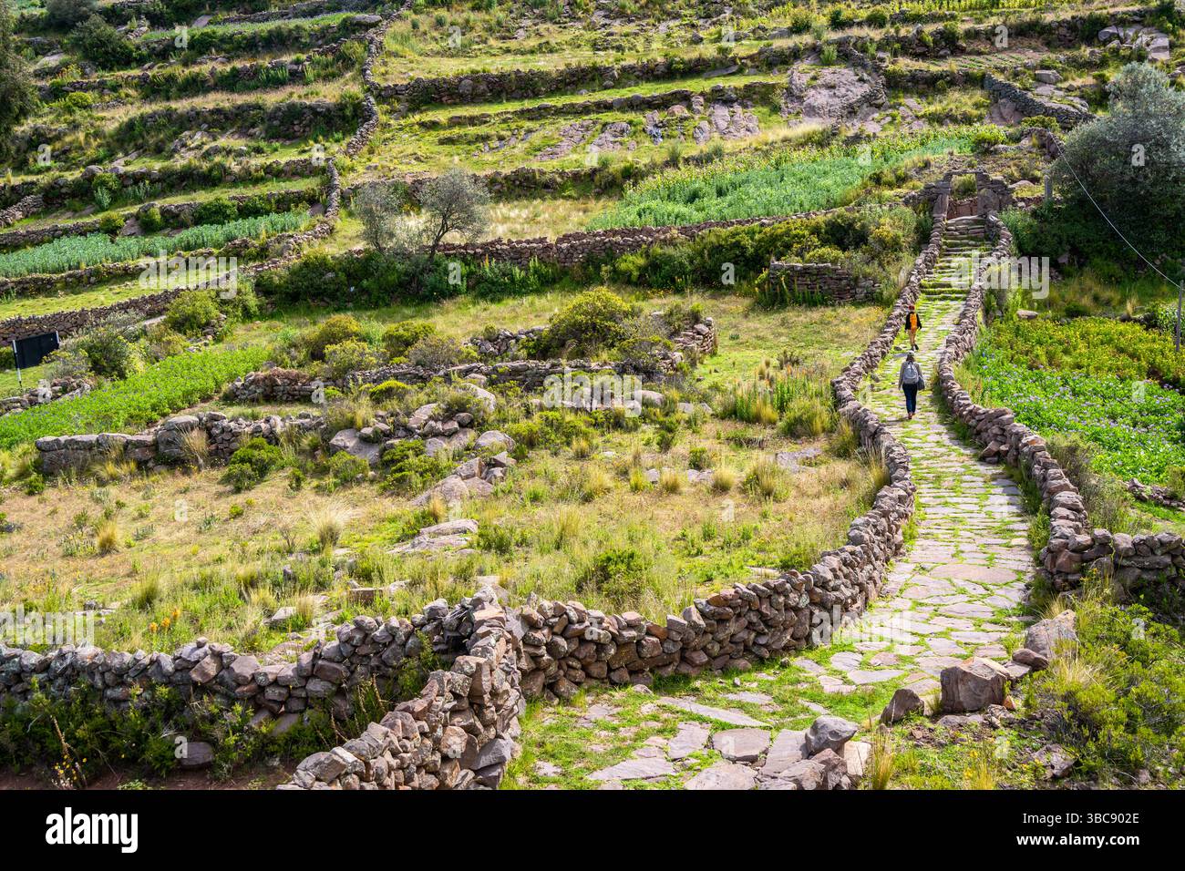 Ancient stone ruins from a pre-Inca civilization stand on Taquile ...
