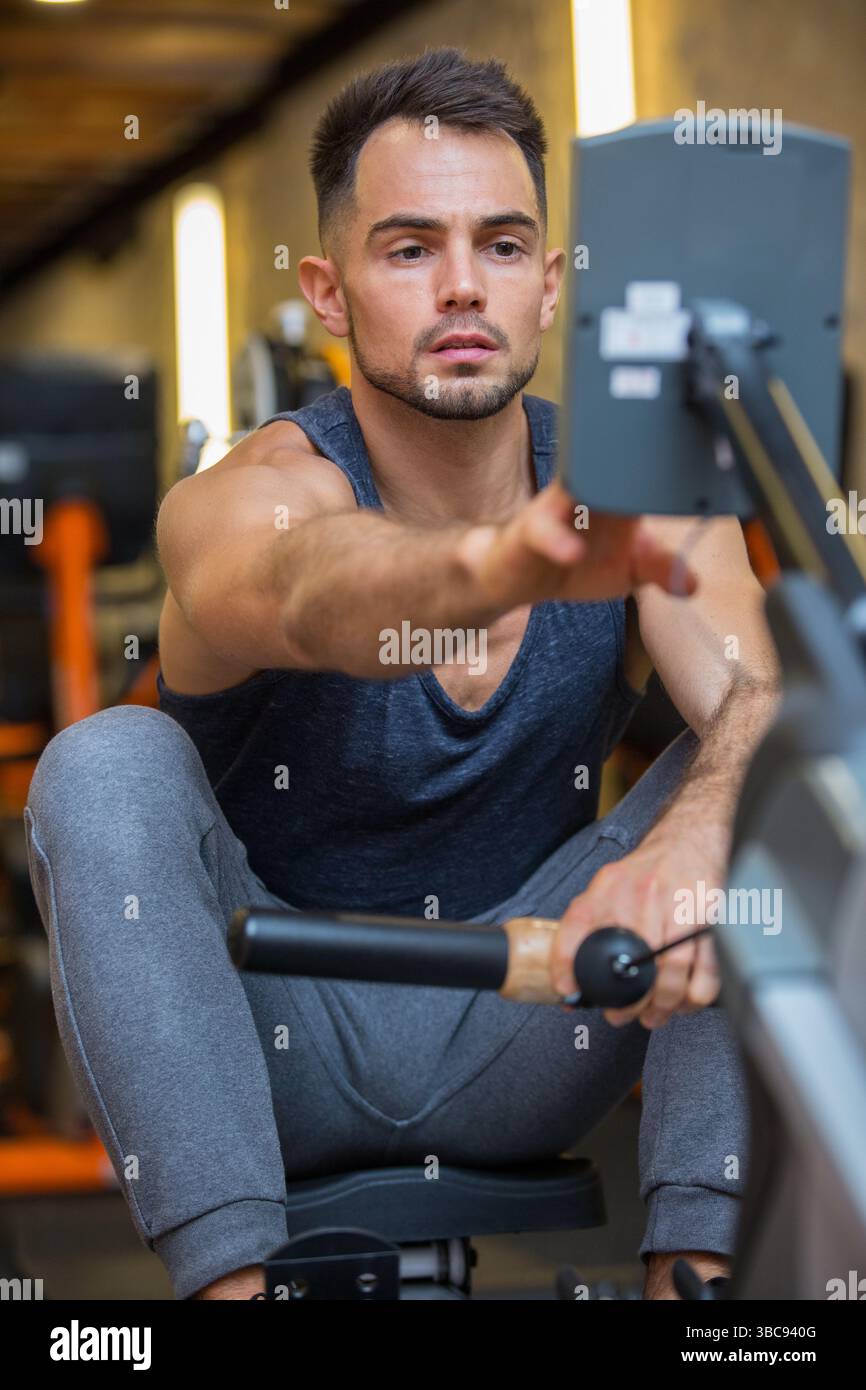 Using rowing machine man exercising hi-res stock photography and images ...