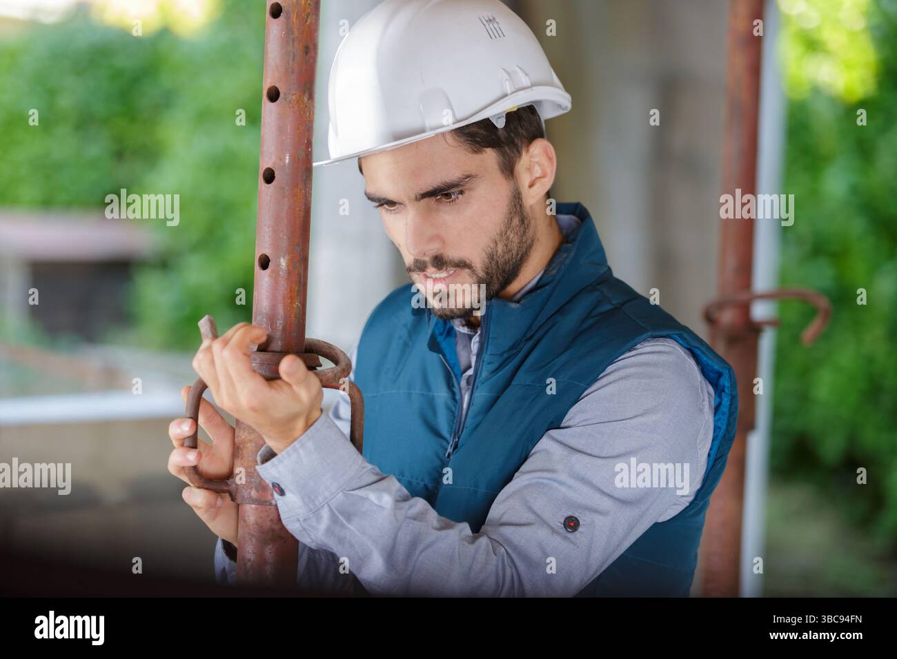 male builder checking pipes state Stock Photo