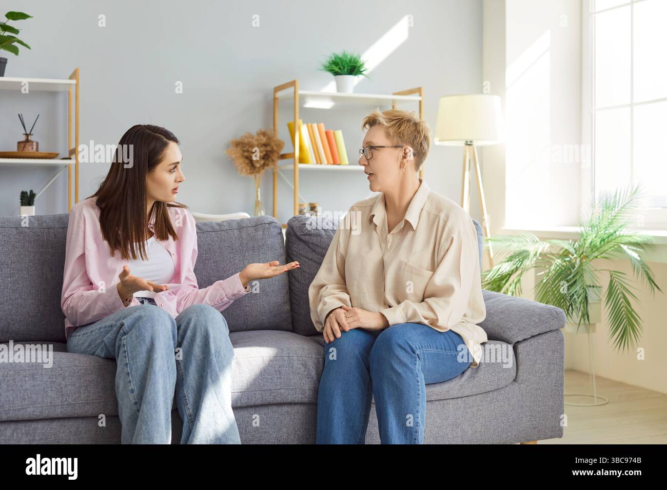 Elderly mother listening to adult daughter expressing concern during ...