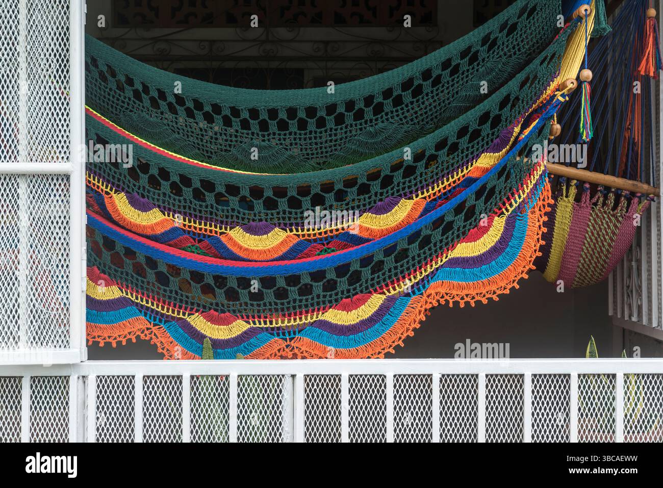 Display of colorful handmade hammocks in a open window of a small family factory in Masaya, Nicaragua. Stock Photo