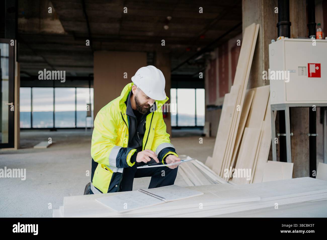 Construction site manager using digital tablet to inspect building progress. Stock Photo
