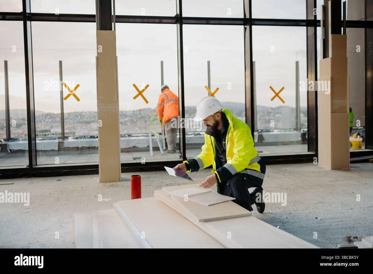 Construction site manager using digital tablet to inspect building progress. Stock Photo