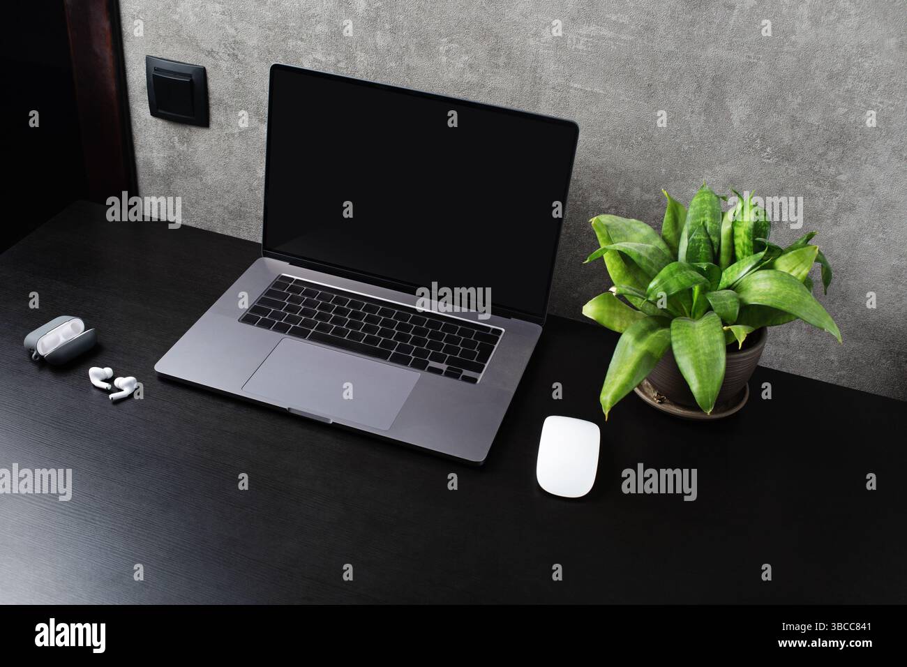 Office gadgets and laptop with blank screen. Stock Photo