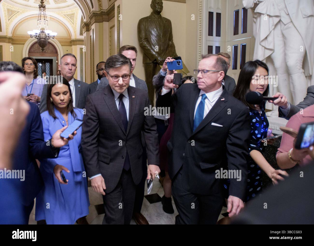 Speaker of the House Mike Johnson, R-La., center, talks with reporters ...