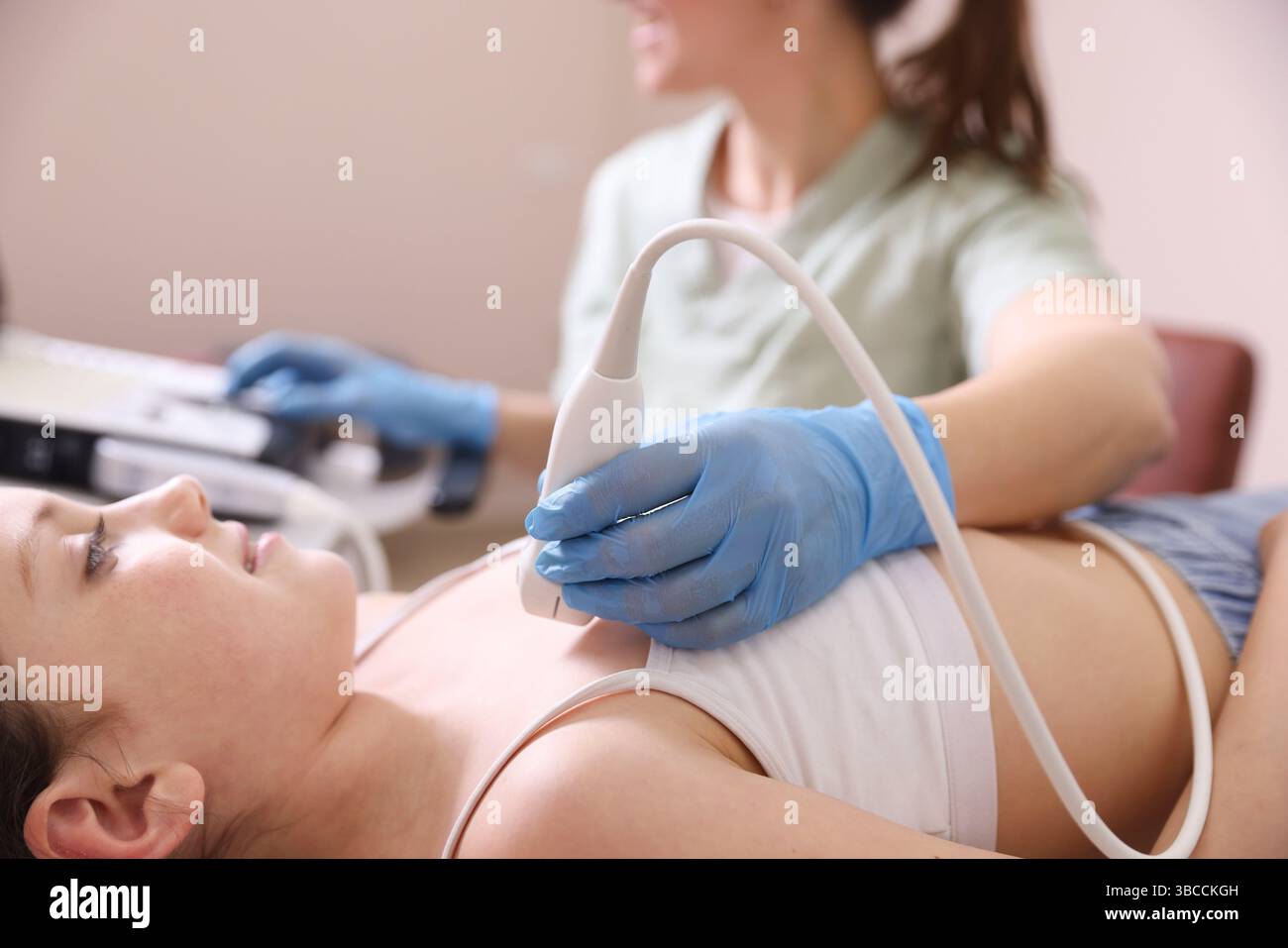 Sonographer Conducting Ultrasound Examination Of Girl s Heart In Clinic sonographer-conducting-ultrasound-examination-of-girl-s-heart-in-clinic