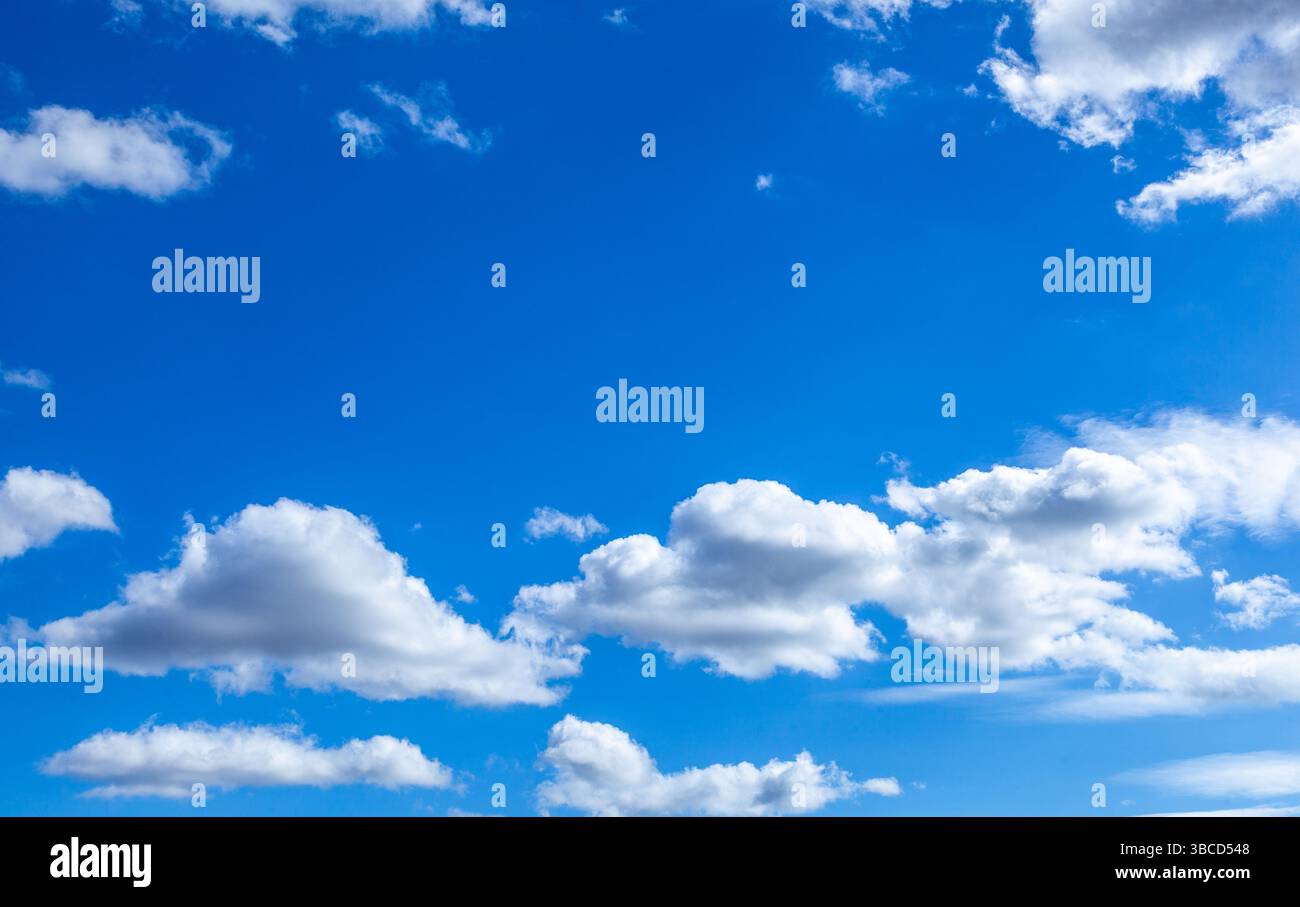 A beautiful blue sky with puffy white clouds. Stock Photo