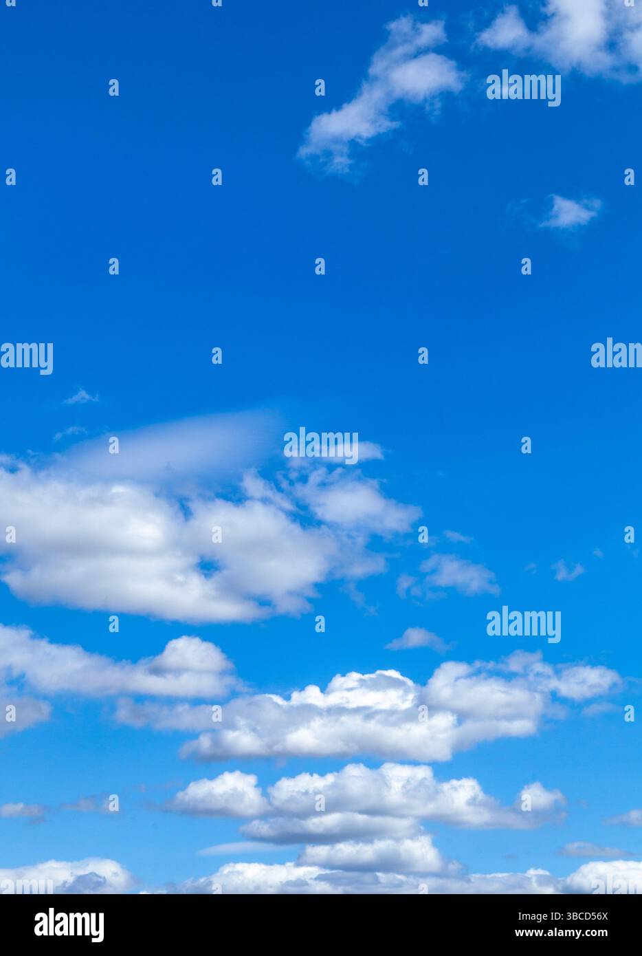 A beautiful blue sky with puffy white clouds. Stock Photo