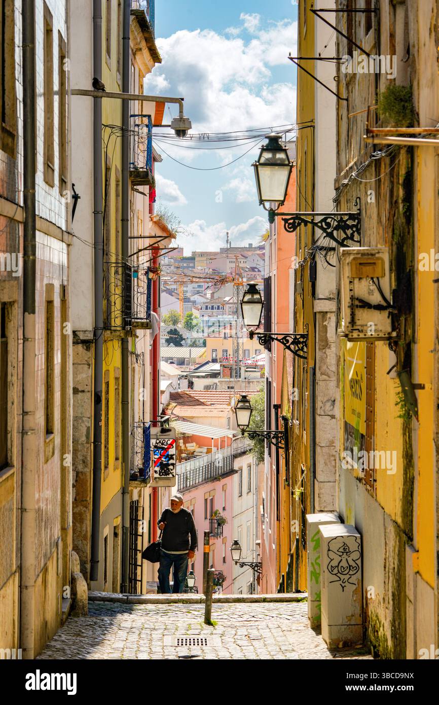 Narrow cobblestone street with traditional colorful buildings and ...