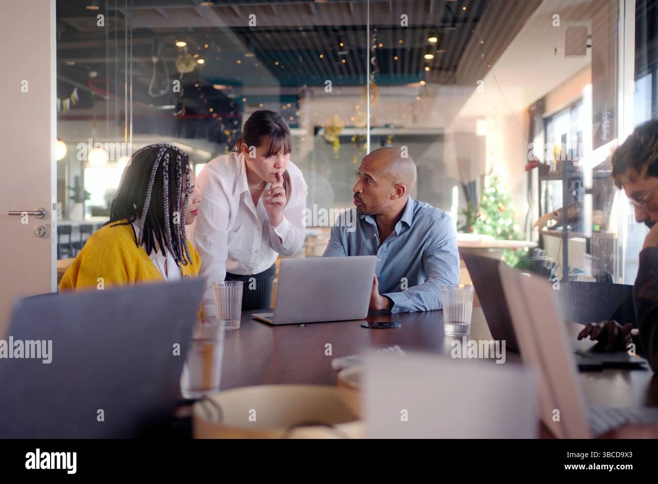 Diverse business team collaborating on project in modern office Stock Photo