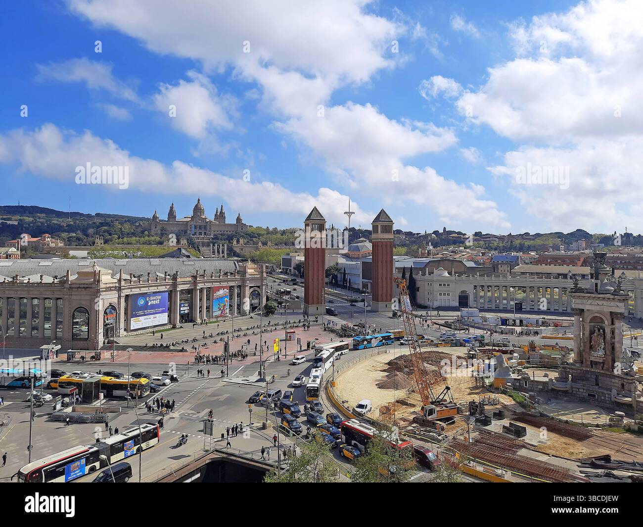 Barcelona Catalonia Spain. April 09 2025. Wide view of Plaça dEspanya with city traffic Venetian Towers MNAC in the background and active construction Stock Photo