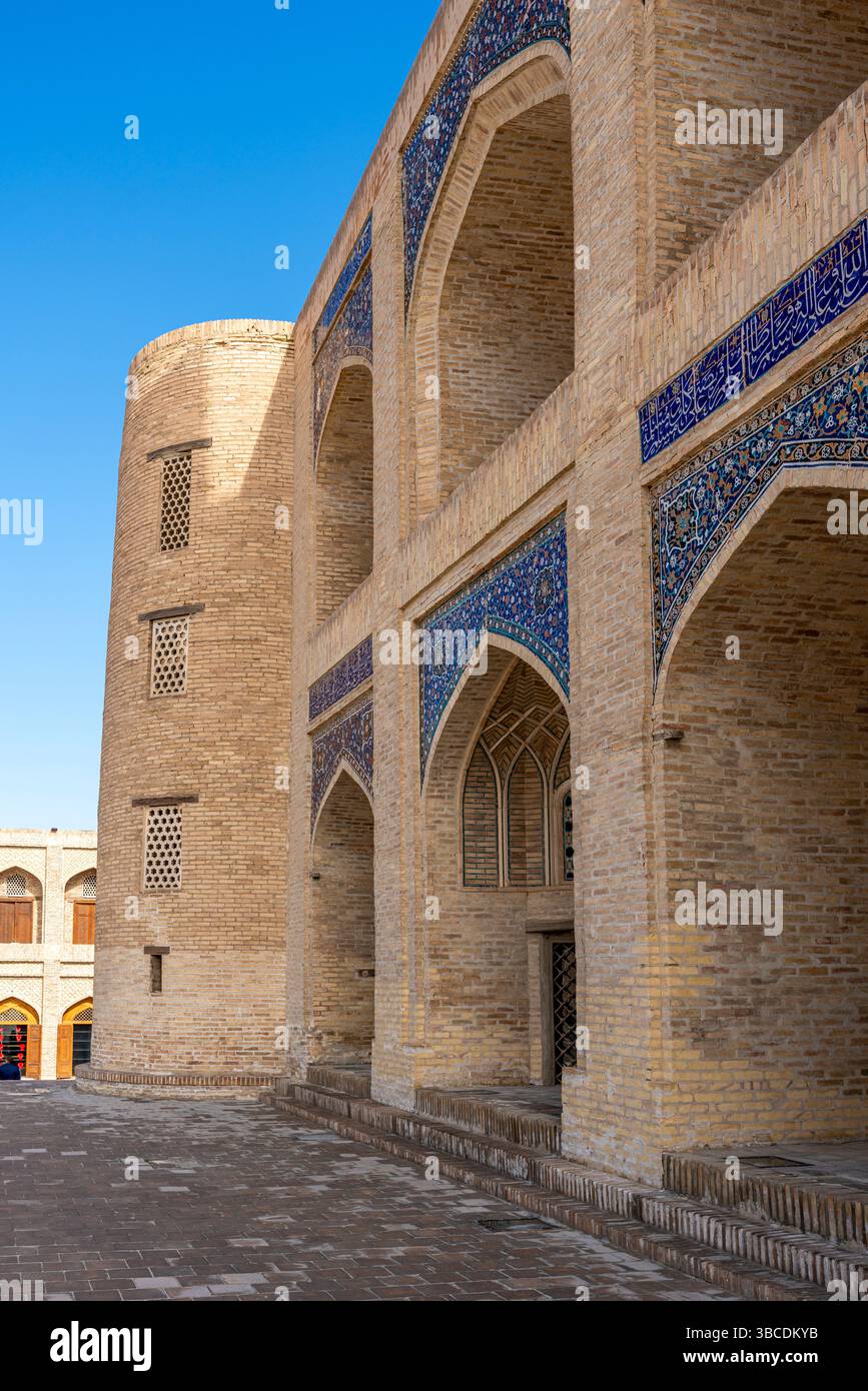 A Long Brick Corridor With Arches Runs Along Mir i Arab Madrasa In a-long-brick-corridor-with-arches-runs-along-mir-i-arab-madrasa-in