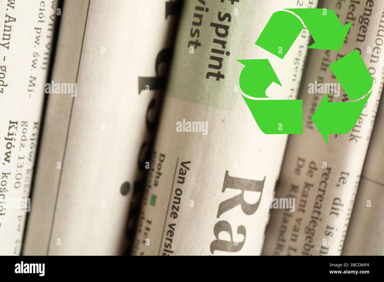 Recycling symbol and many newspapers in different languages as ...