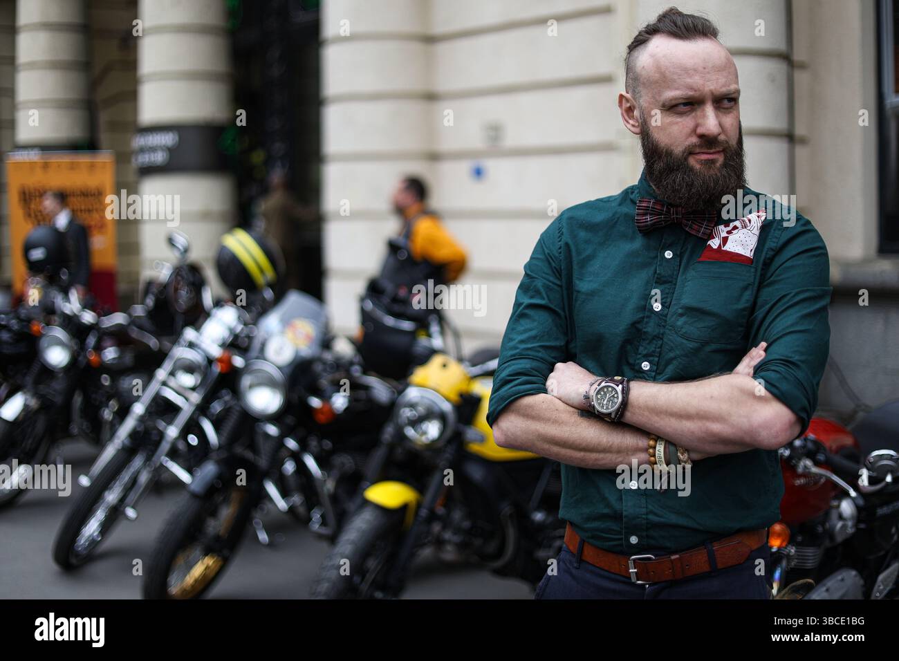 Participants for the Distinguished Gentleman's Ride gather next to ...