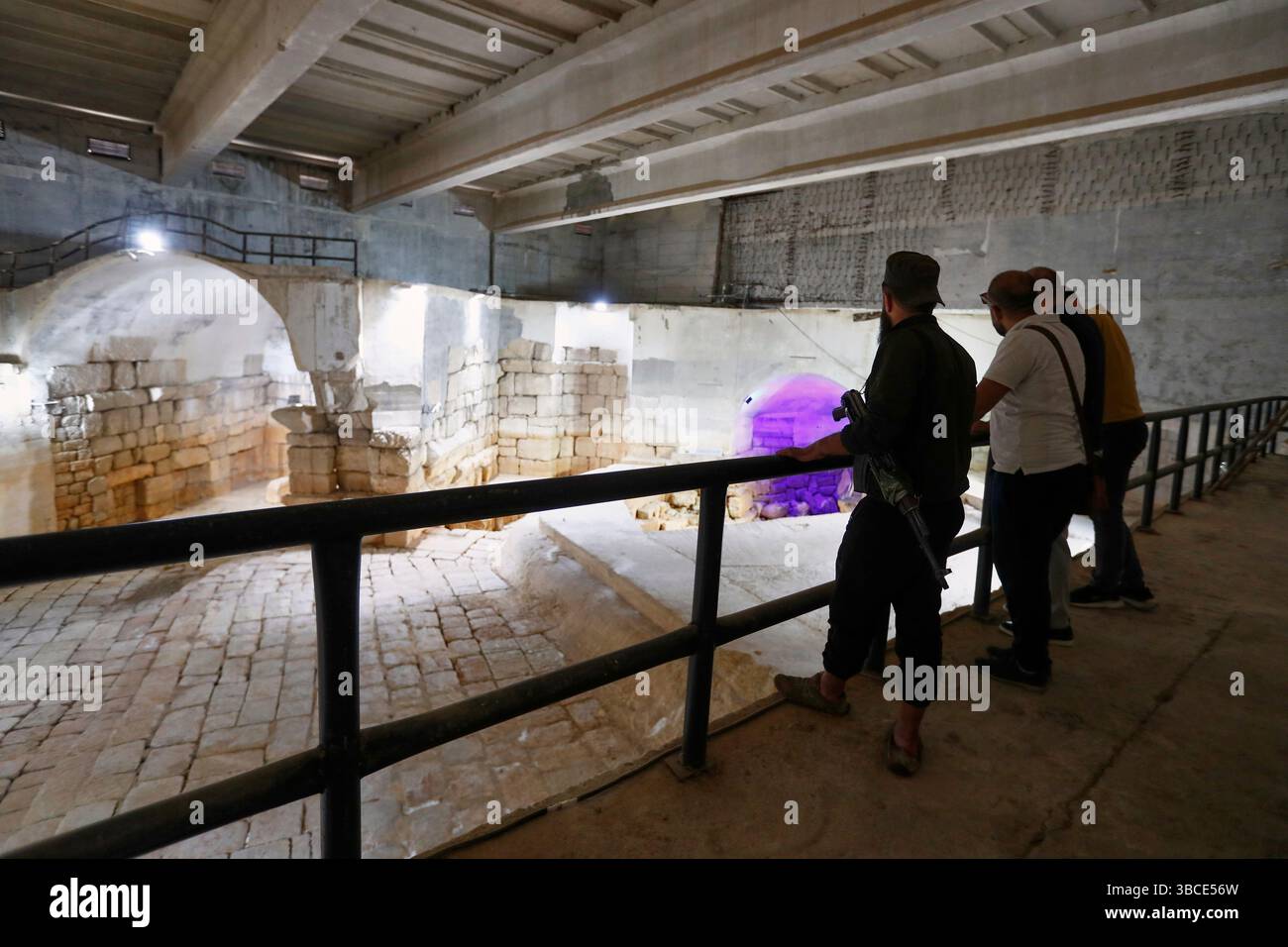 Visitors watch the dry main reservoir of the spring in Ein el-Fijeh ...