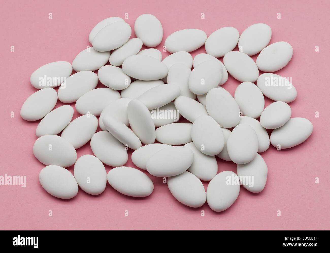 Jordan almonds isolated on pink background. Stock Photo