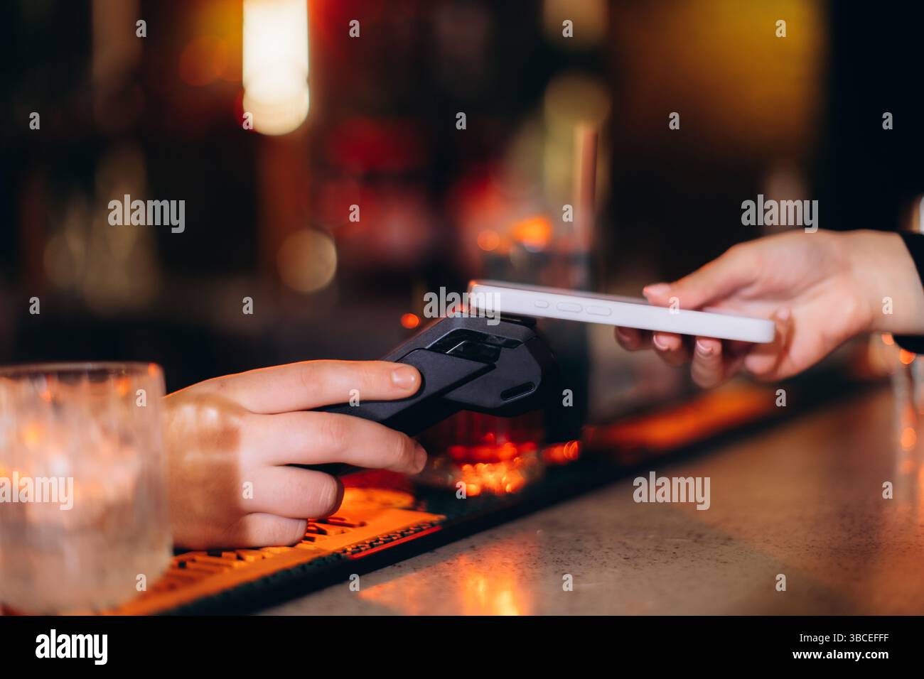 Contactless Mobile Payment in Action at a Stylish Modern Bar Stock Photo