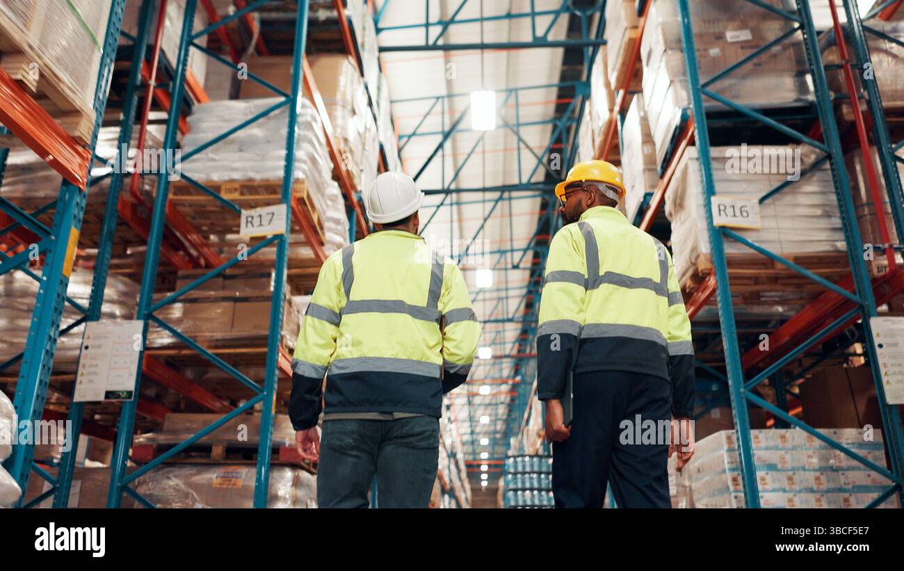 Low angle, back and people at distribution warehouse for shipping ...