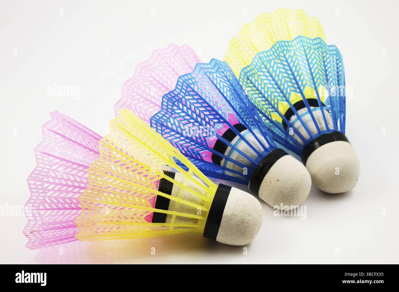 Shuttlecocks in different colors on white background Stock Photo
