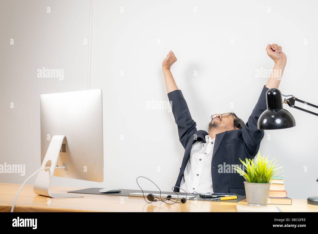 Work-life balance in action, a businessman takes a moment to stretch ...