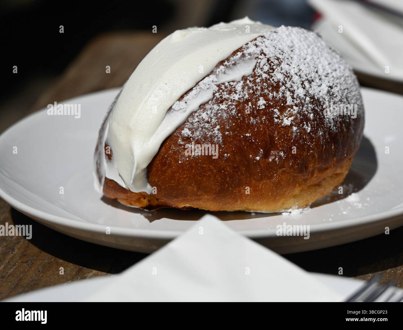 Italian Cream Bun (Maritozzo) on white plate Stock Photo