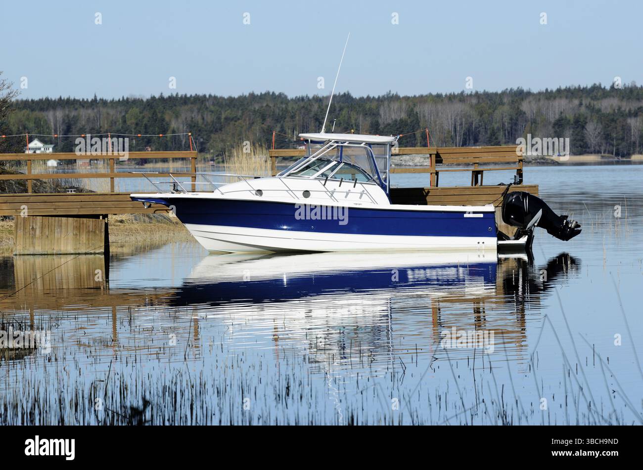 Big white boat tied up at the wooden pier Stock Photo - Alamy