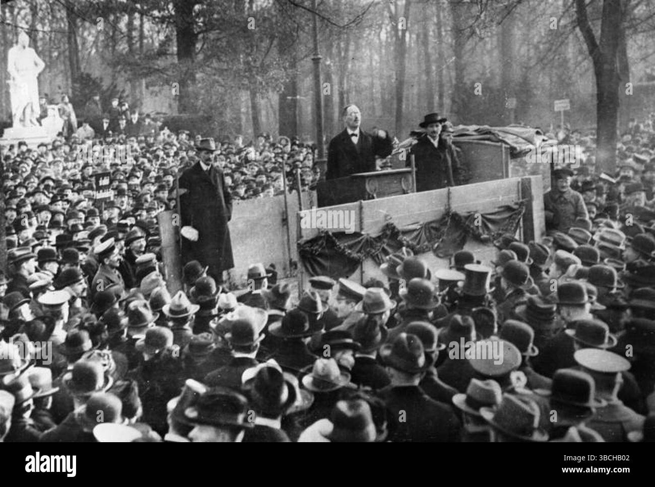Karl Liebknecht speaking to a large group in Berlin's Tiergarten. Karl Liebknecht (13 August 1871 – 15 January 1919)) was a German revolutionary and Marxist theorist. He was a key figure of the socialist movements in Germany in the early 20th century. He was, with Rosa Luxemberg, a leader of the Spartacus League who organised an armed revolution in Berlin (the Spartacist Uprising) to install a communist leadership. Image By Bundesarchiv, B 145 Bild-P046271 / Weinrother, Carl / CC-BY-SA 3.0 Stock Photo