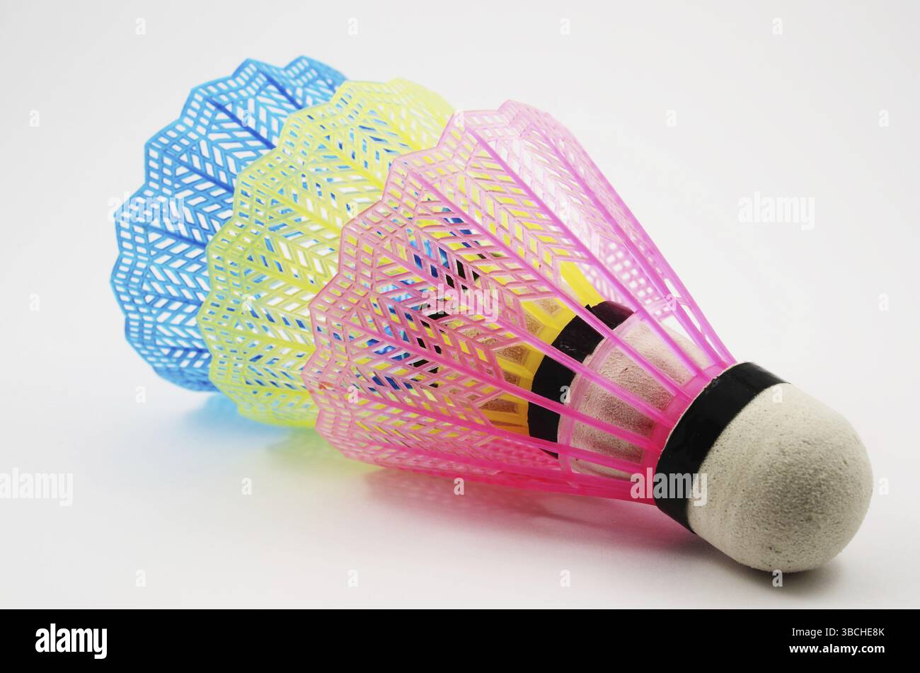 Shuttlecocks in different colors on white background Stock Photo