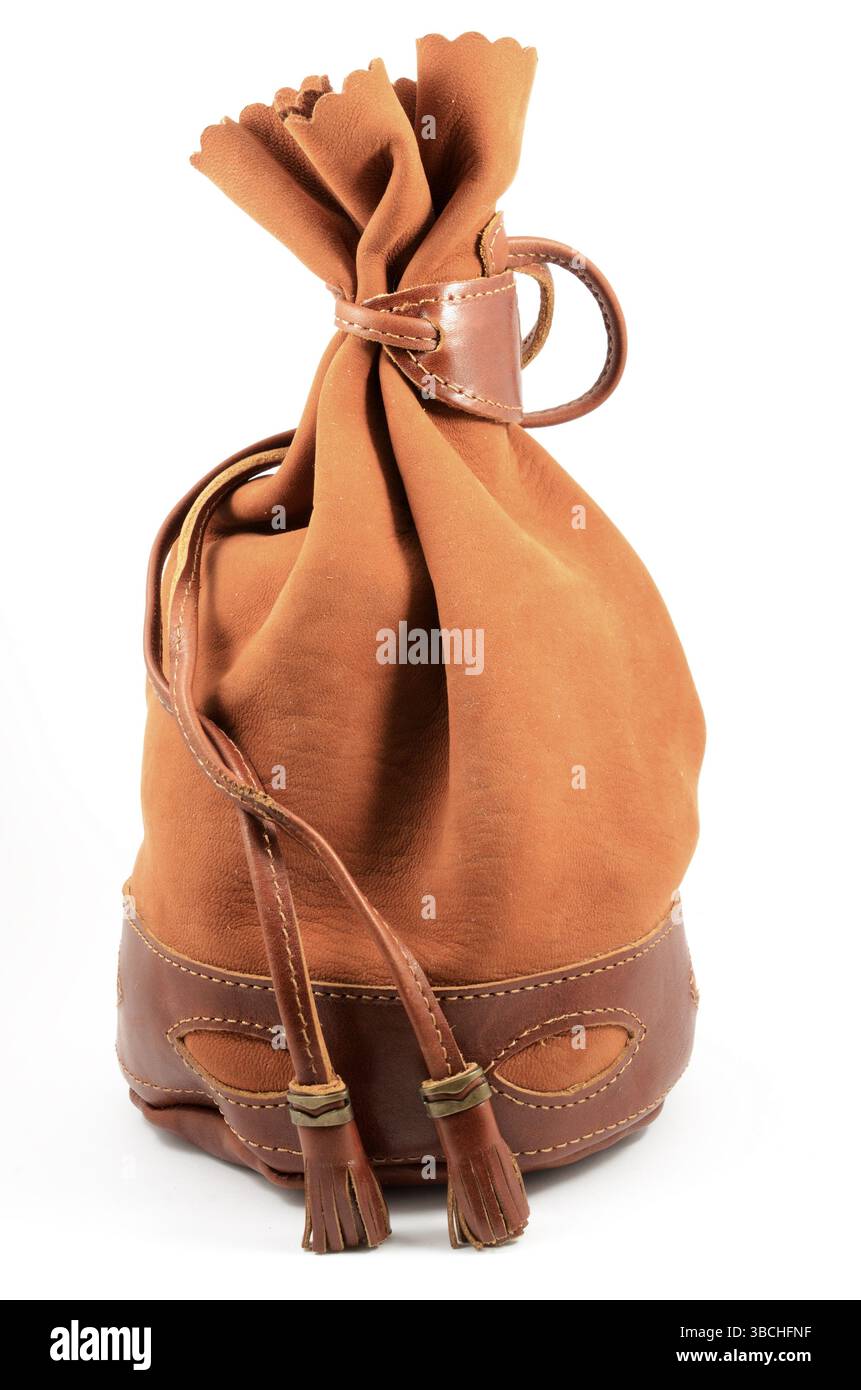 Brown suede pouch on white background, vertical Stock Photo